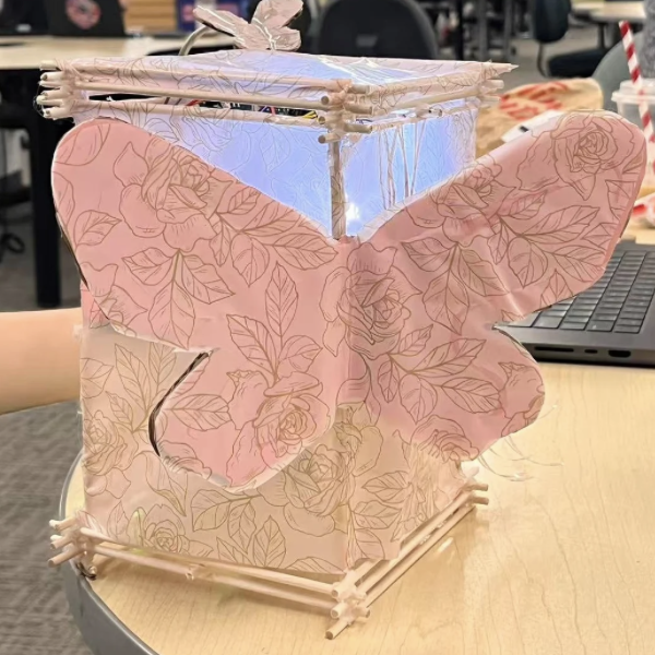 The decorated prototype with butterfly cutouts and glowing LED light, showing the final look of lamp.